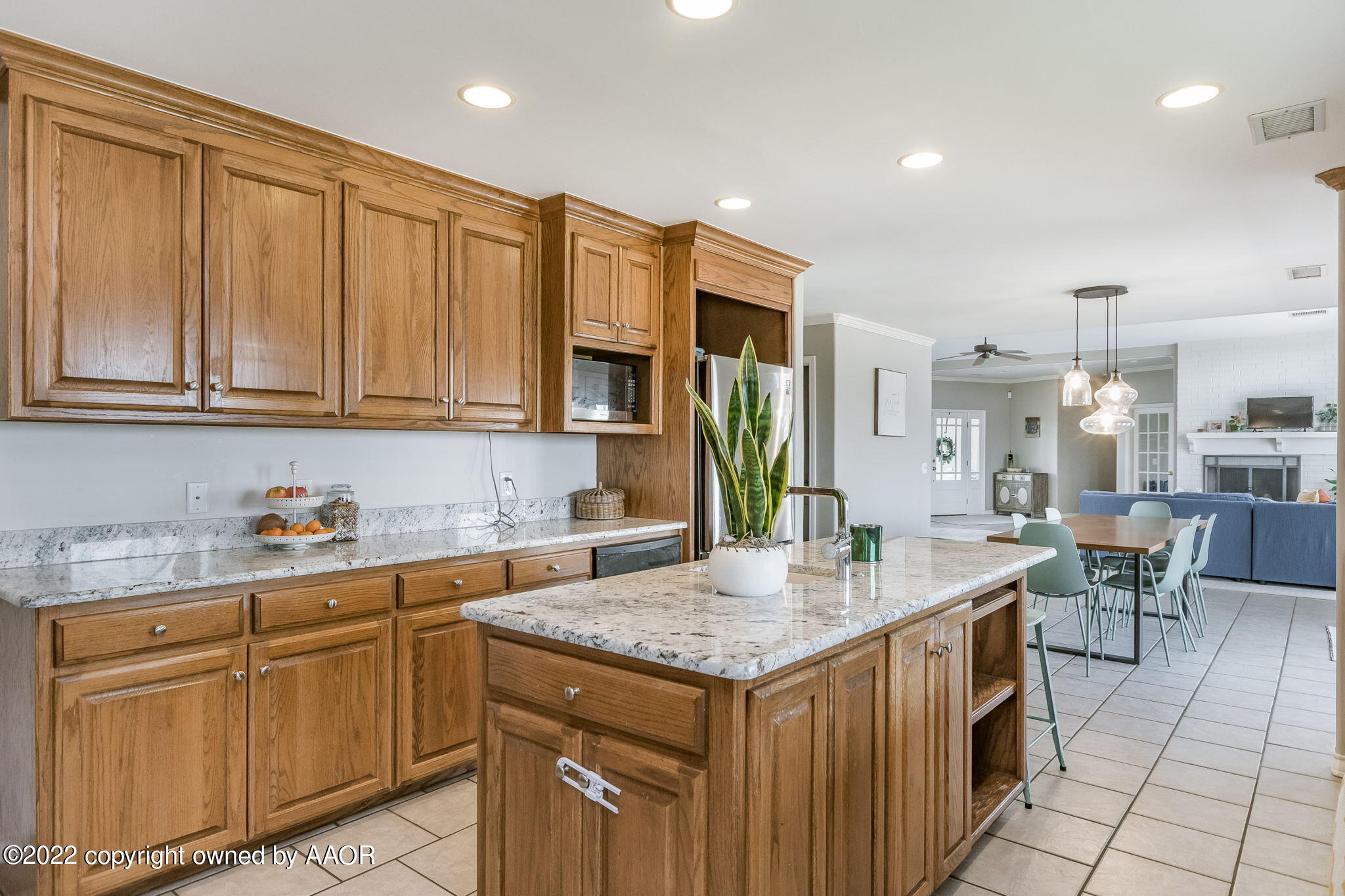 327 Lake Ridge Road Canyon, TX 79015 - Photo 12 of 31 a kitchen with granite countertop a sink a stove cabinets and wooden floor