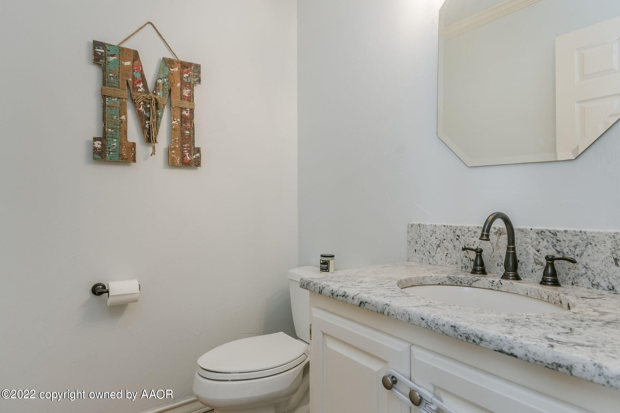 327 Lake Ridge Road Canyon, TX 79015 - Photo 13 of 31 a bathroom with a granite countertop sink vanity mirror and toilet