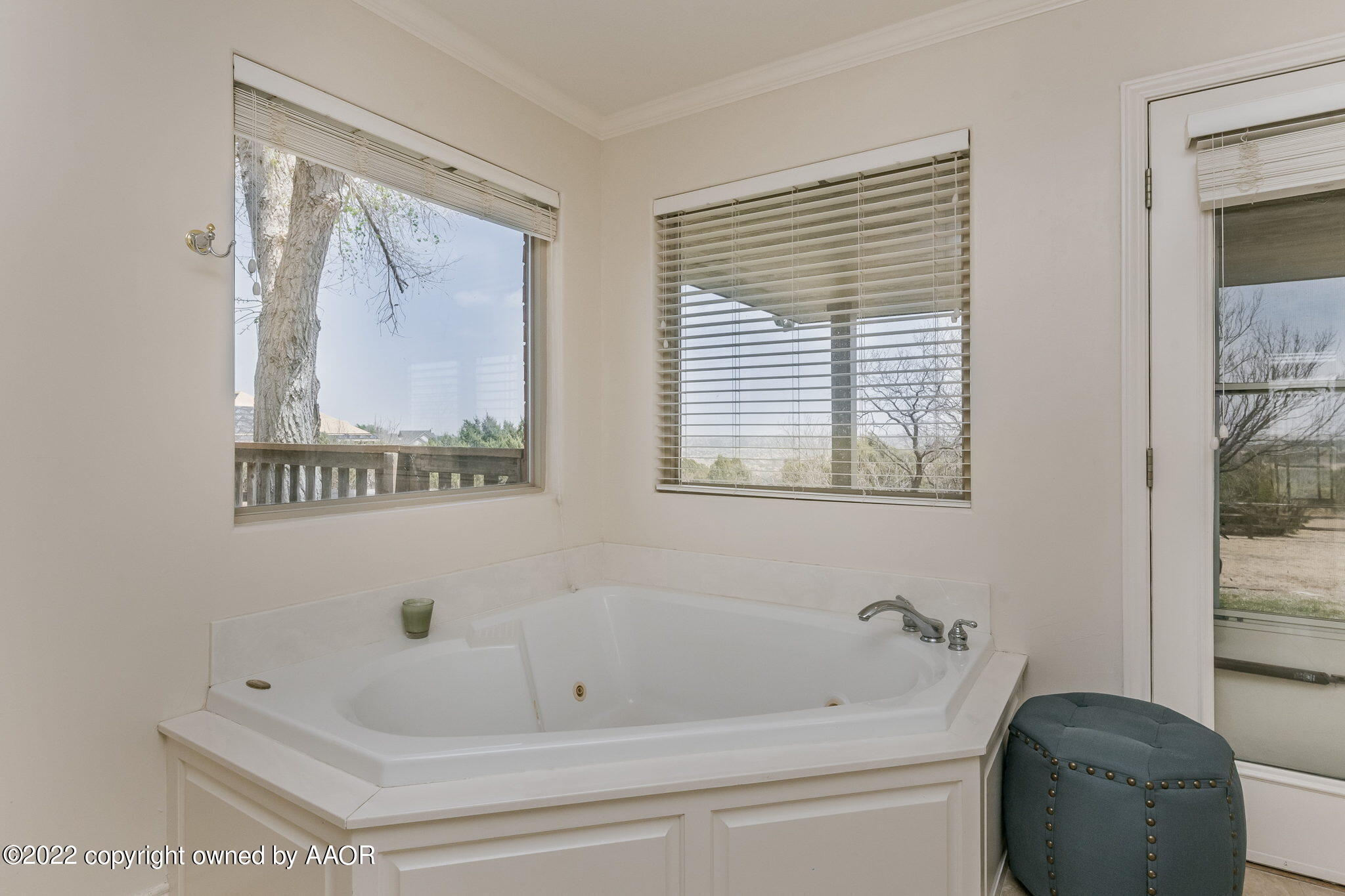 327 Lake Ridge Road Canyon, TX 79015 - Photo 17 of 31 a bathroom with a bathtub and a window