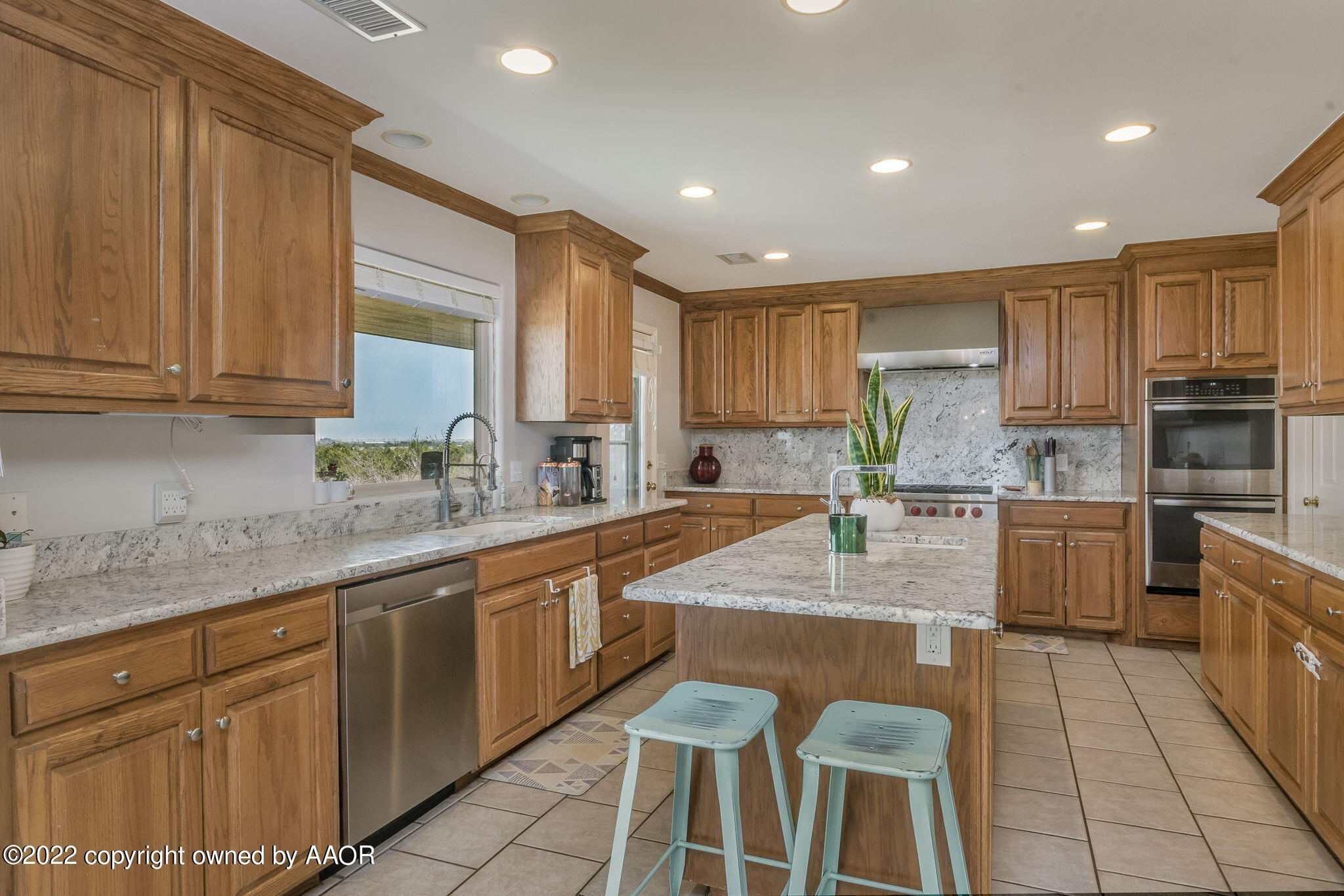327 Lake Ridge Road Canyon, TX 79015 - Photo 9 of 31 a large kitchen with granite countertop lots of white cabinets