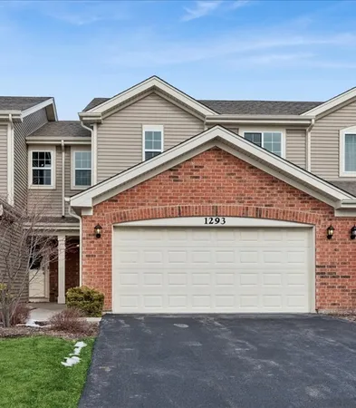 a view of a house with a yard and garage