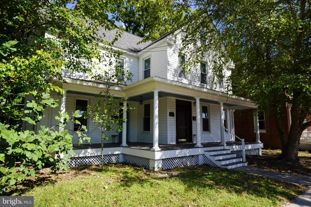 a front view of house with yard outdoor seating and green space