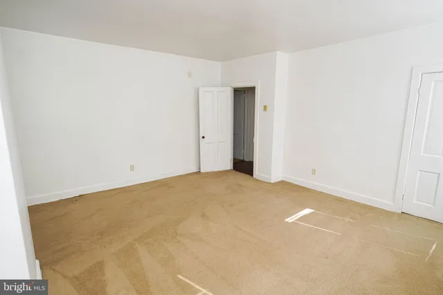 a bathroom with a toilet a window and a shower