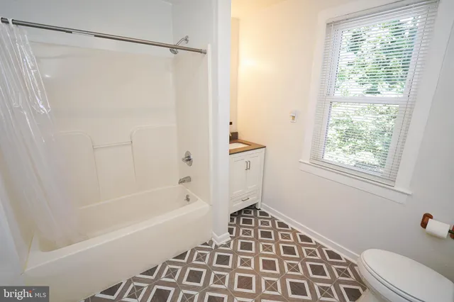 a bathroom with a shower and a bathtub