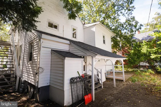 a view of a patio with table and chairs and potted plants