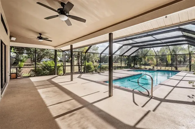 a view of a patio with a table and chairs under an umbrella