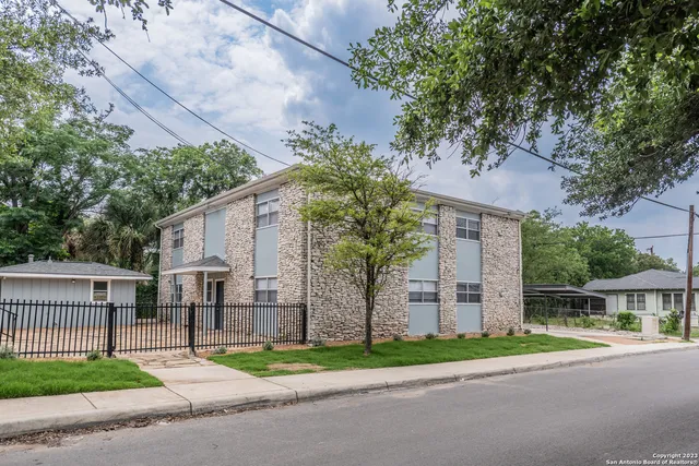 a view of road with a house in the background
