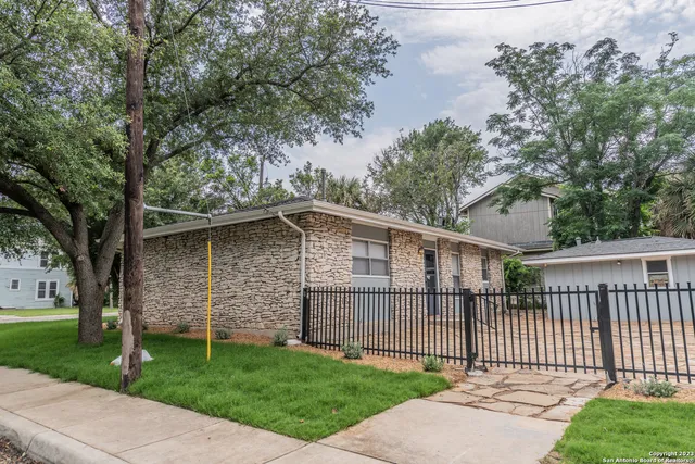 a view of a wooden house with a yard