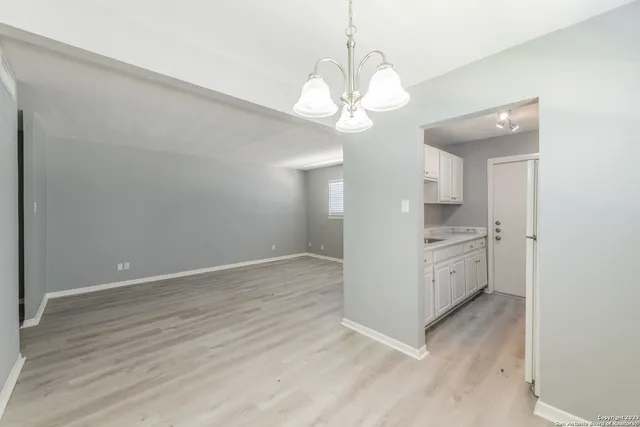 a view of a kitchen with a dishwasher cabinets and wooden floor