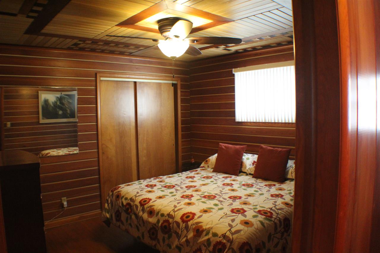 3421 North View Road Rockford, IL 61107 - Photo 14 of 24 a bedroom with a bed and a chandelier