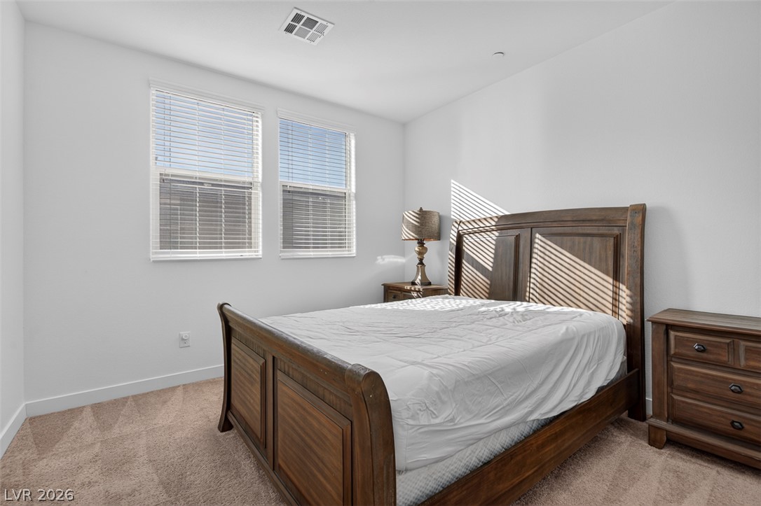 1100 East Sunset Road Henderson, NV 89011 - Photo 36 of 58 Warm sunlight streams into this spacious bedroom, creating a tranquil retreat.