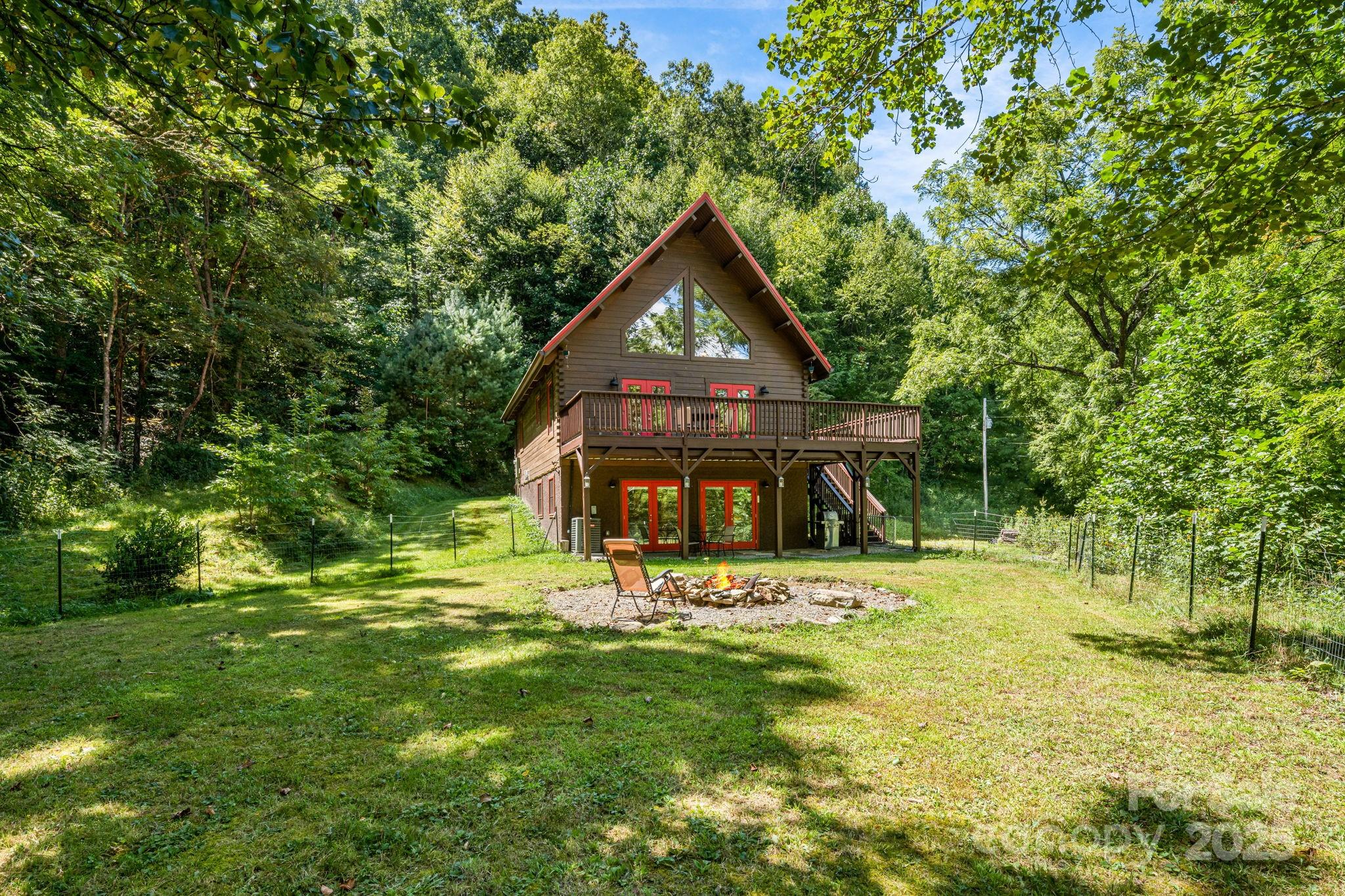 6018 Meadow Fork Road Hot Springs, NC 28743 - Photo 2 of 31 a view of a house with a big yard and large trees