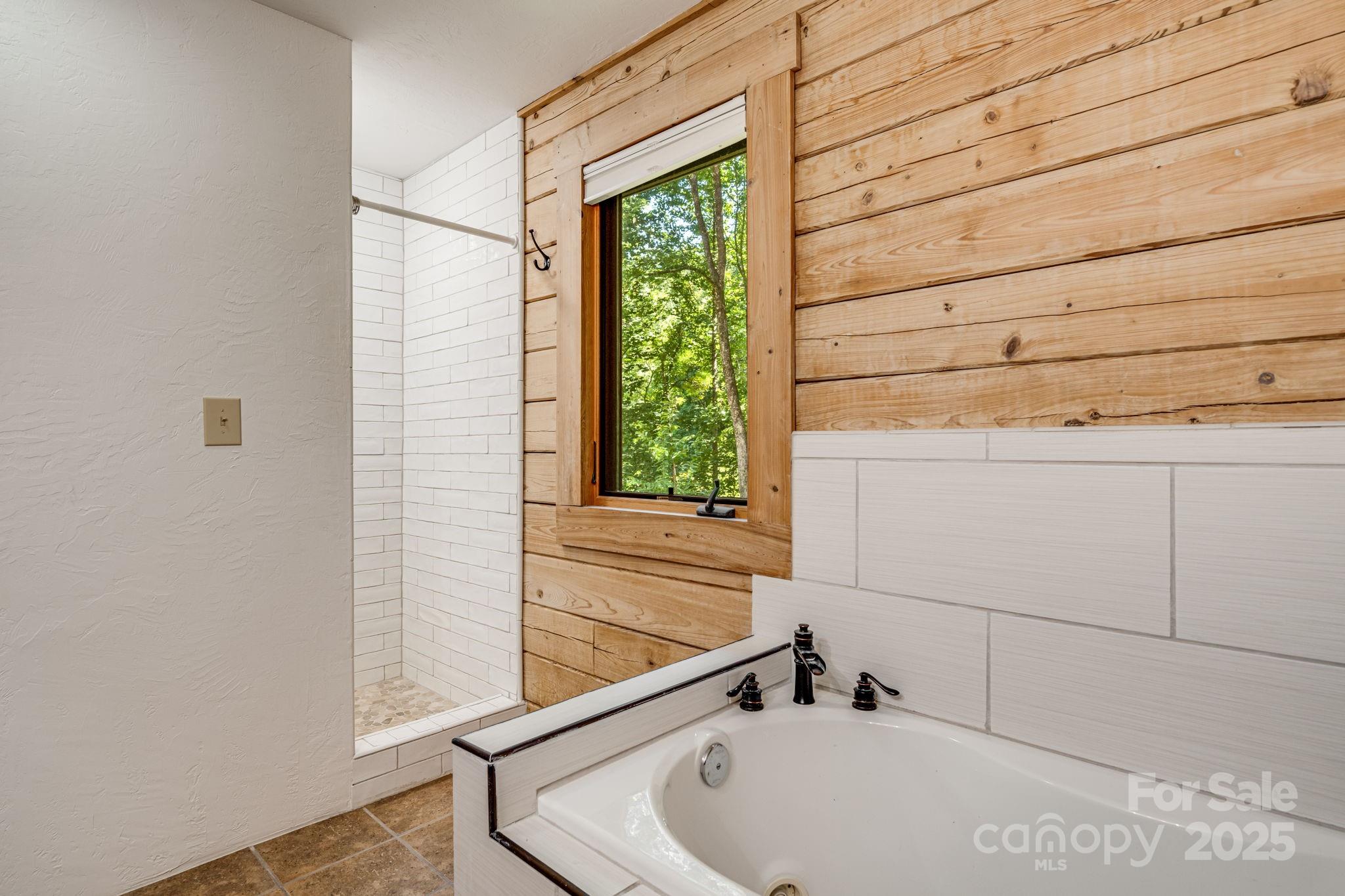 6018 Meadow Fork Road Hot Springs, NC 28743 - Photo 21 of 31 a bathroom with a tub and window