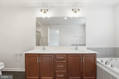 a bathroom with a sink vanity and a mirror