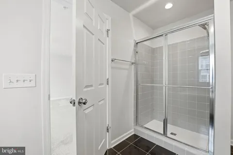 a bathroom with a glass shower door