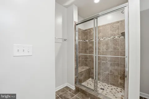 a bathroom with a glass shower door