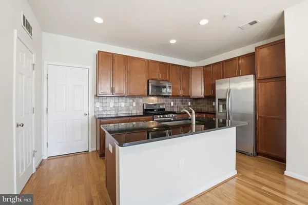 a kitchen with a refrigerator sink and microwave