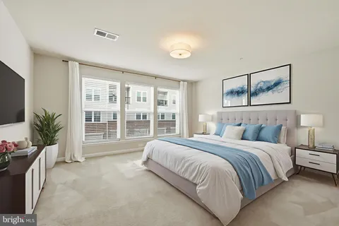 a spacious bedroom with a large bed and a large window