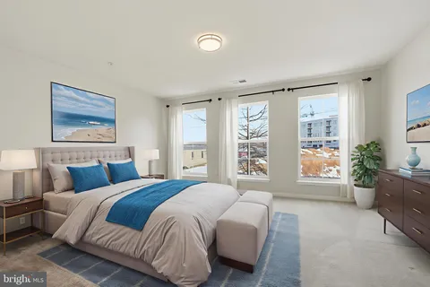 a bedroom with a large bed and a couch