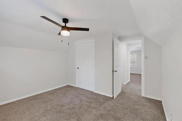 a view of a room with a ceiling fan