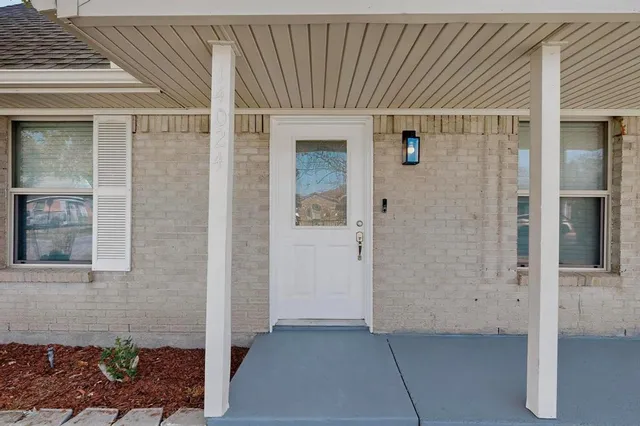 a view of a brick house with a wooden door