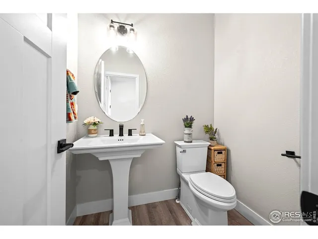 a bathroom with a sink mirror and toilet