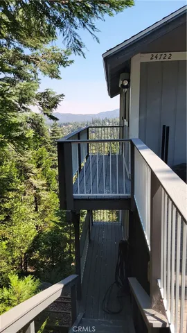 a view of backyard with small cabin and wooden fence