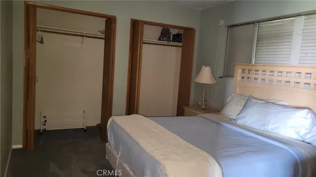 a bedroom with a bed and a table in it