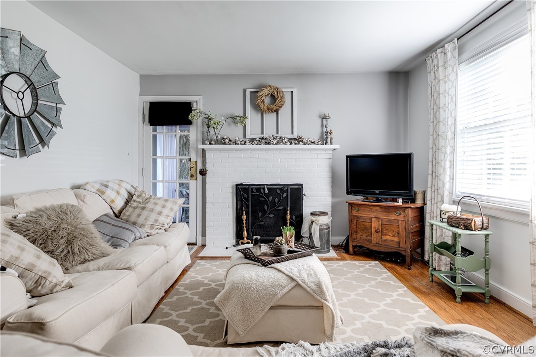 3926 Brook Road Richmond, VA 23227 - Photo 3 of 25 a living room with furniture a flat screen tv and a fireplace