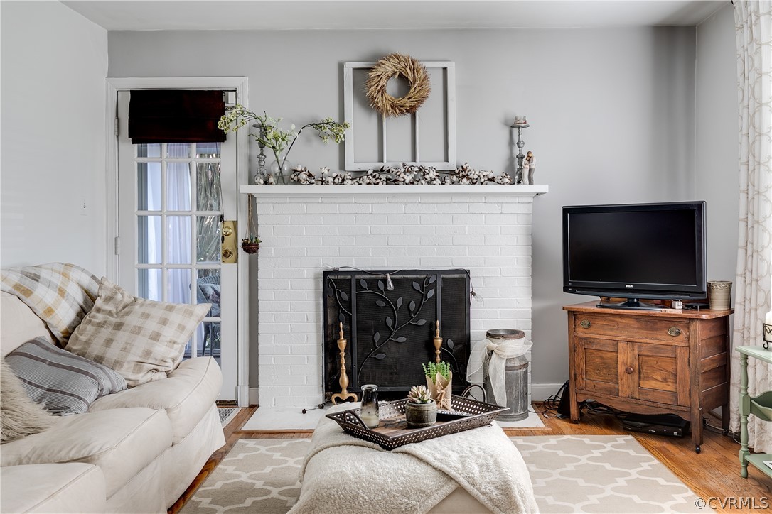 3926 Brook Road Richmond, VA 23227 - Photo 4 of 25 a living room with furniture a flat screen tv and a fireplace