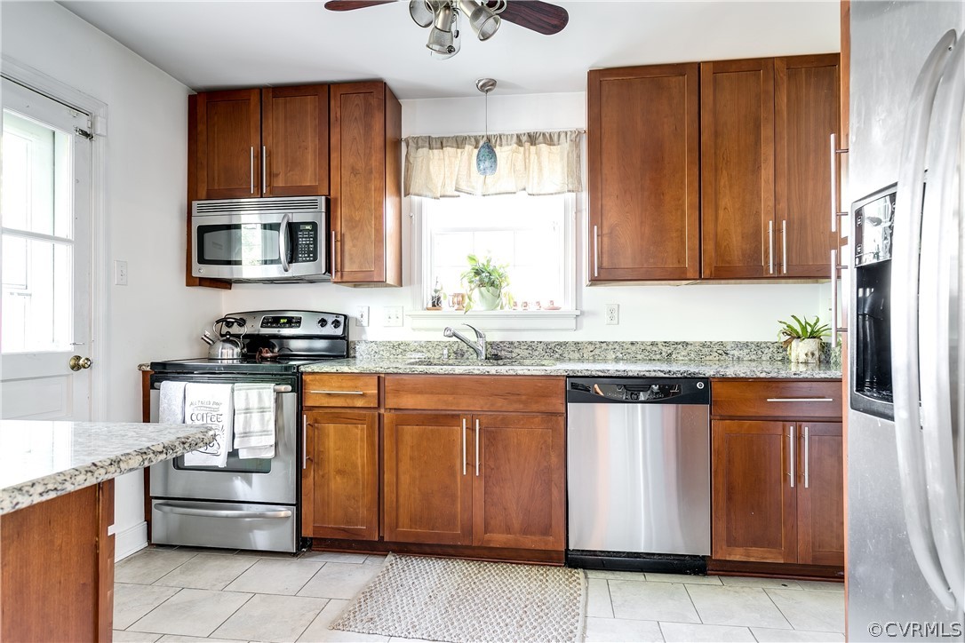 3926 Brook Road Richmond, VA 23227 - Photo 9 of 25 a kitchen with stainless steel appliances granite countertop a stove a sink and a microwave