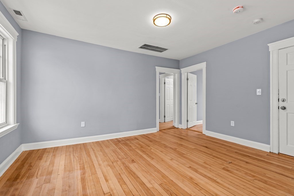 8 Massasoit Road Worcester, MA 01604 - Photo 11 of 21 a view of an empty room with wooden floor and a window