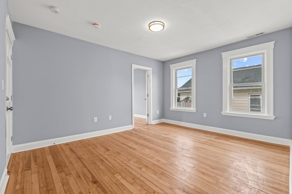 8 Massasoit Road Worcester, MA 01604 - Photo 12 of 21 a view of an empty room with wooden floor and a window