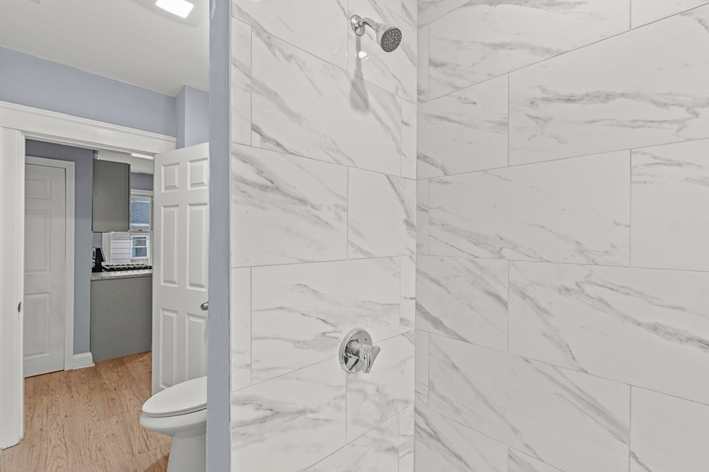 8 Massasoit Road Worcester, MA 01604 - Photo 13 of 21 a bathroom with a granite countertop sink a toilet and shower