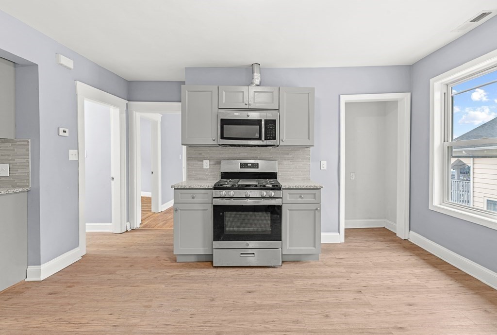 8 Massasoit Road Worcester, MA 01604 - Photo 16 of 21 a kitchen with granite countertop a stove and a sink