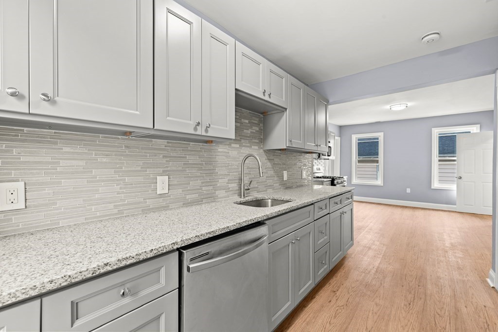 8 Massasoit Road Worcester, MA 01604 - Photo 17 of 21 a kitchen with granite countertop a sink and cabinets