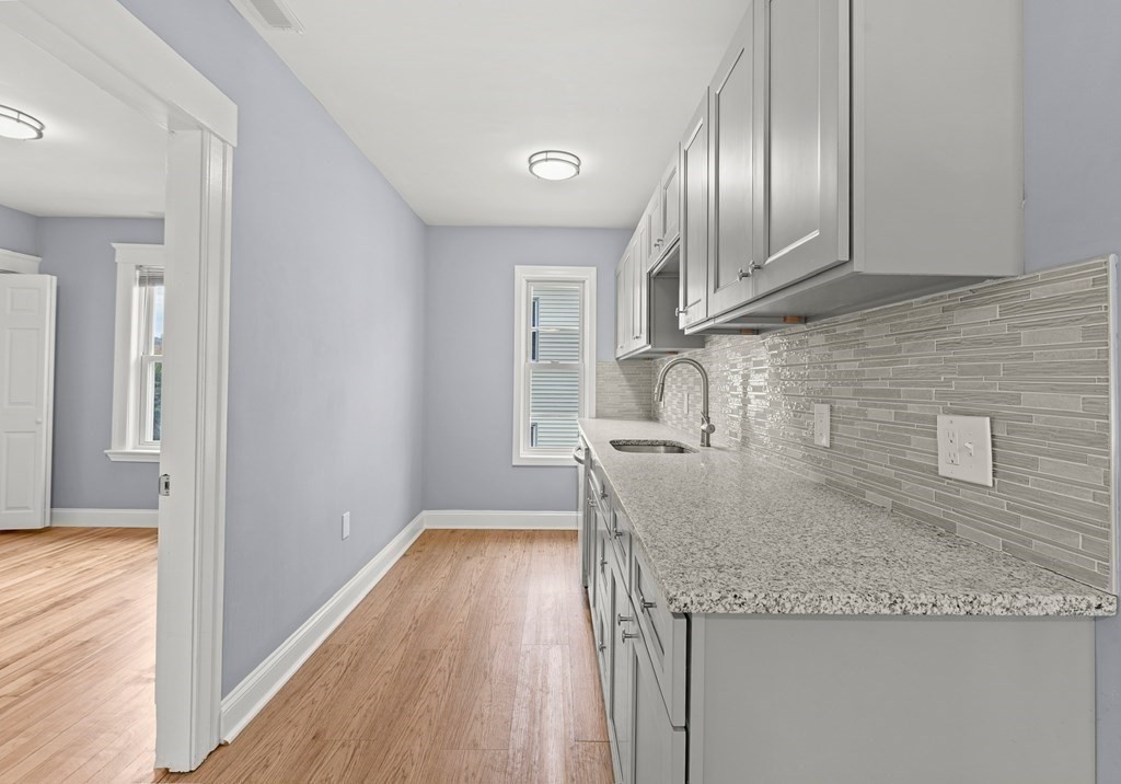8 Massasoit Road Worcester, MA 01604 - Photo 19 of 21 a kitchen with granite countertop wooden cabinets a sink and dishwasher