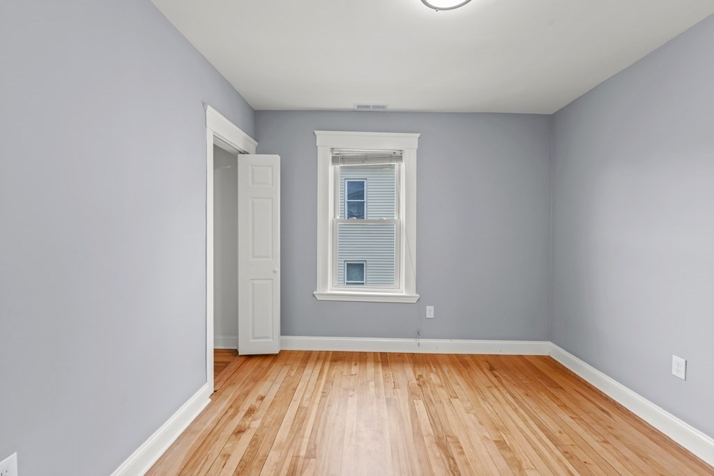 8 Massasoit Road Worcester, MA 01604 - Photo 21 of 21 a view of an empty room with wooden floor and a window