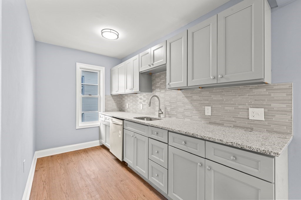 8 Massasoit Road Worcester, MA 01604 - Photo 3 of 21 a kitchen with sink cabinets and window