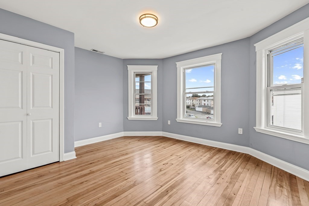 8 Massasoit Road Worcester, MA 01604 - Photo 6 of 21 an empty room with wooden floor and windows