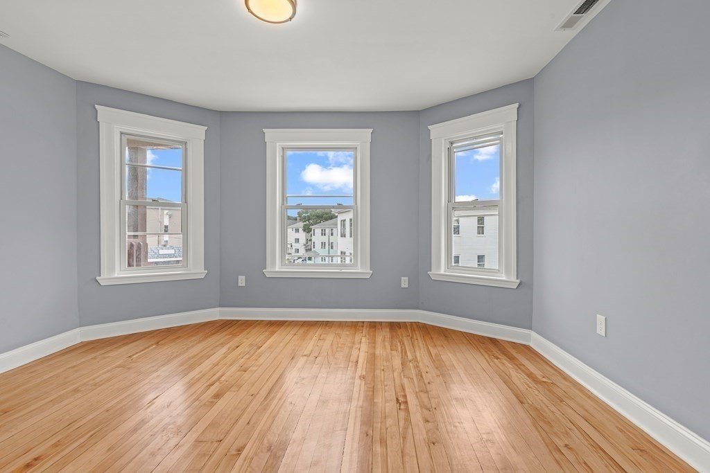 8 Massasoit Road Worcester, MA 01604 - Photo 7 of 21 a view of empty room with wooden floor and fan