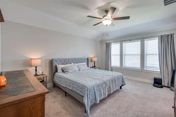 a bedroom with a large bed and flat tv