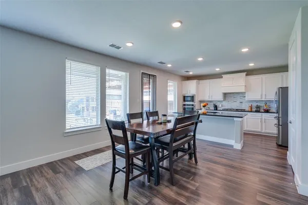 a view of a dining room with furniture and wooden floor