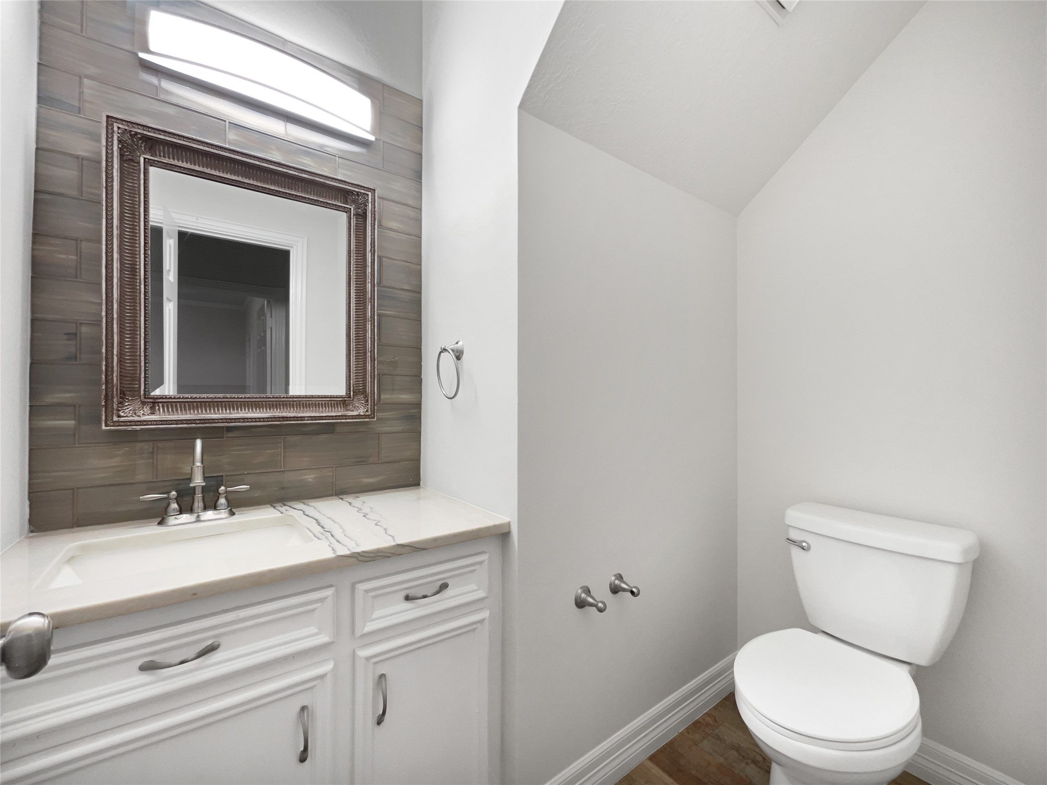 6107 Hampton Way Court Spring, TX 77389 - Photo 12 of 22 a bathroom with a toilet a sink and mirror