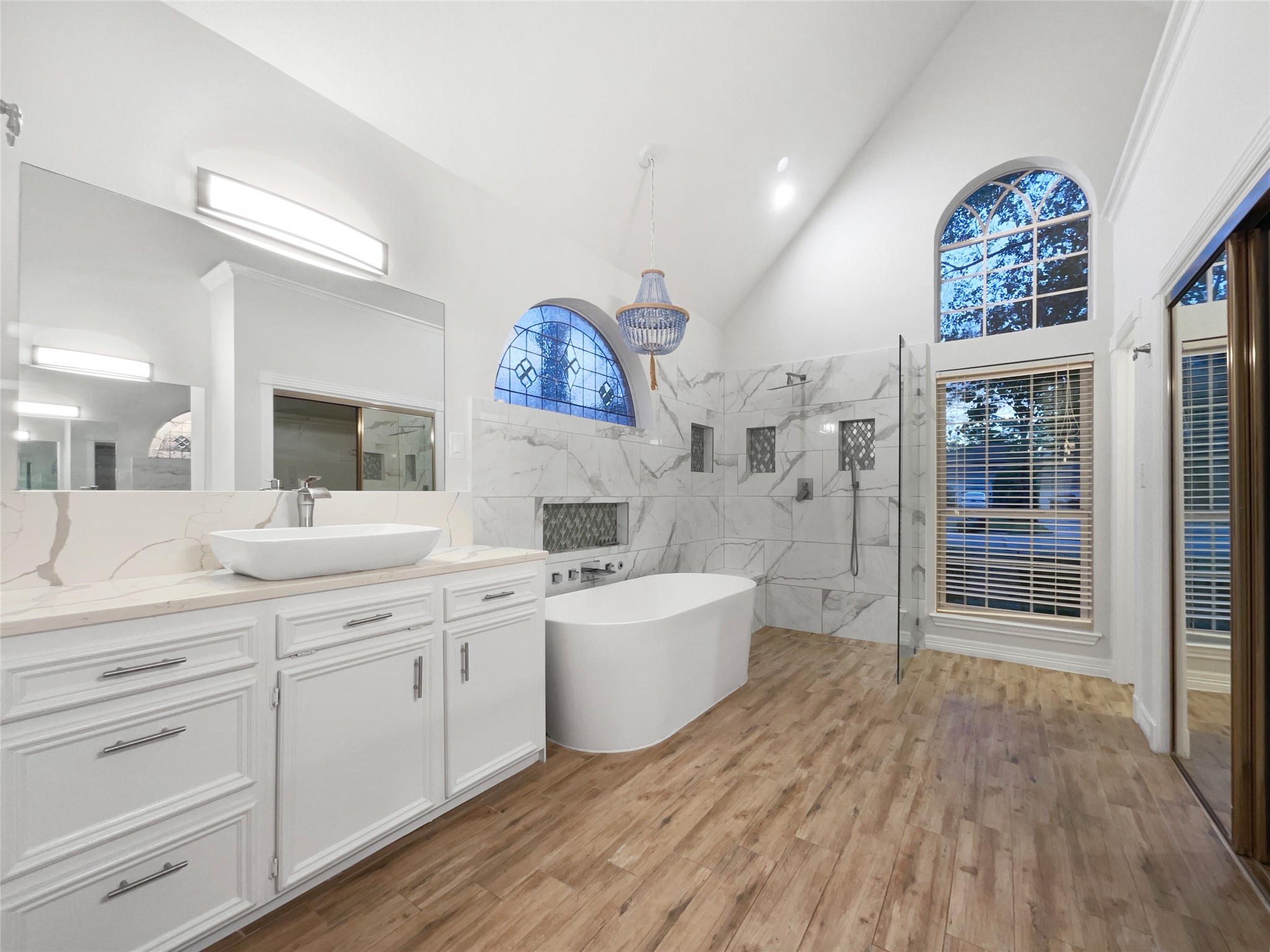 6107 Hampton Way Court Spring, TX 77389 - Photo 13 of 22 a spacious bathroom with a double vanity sink a two mirror a bathtub and a shower