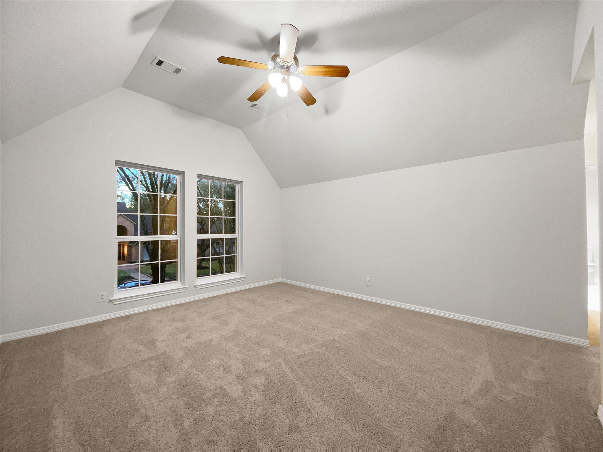 6107 Hampton Way Court Spring, TX 77389 - Photo 18 of 22 an empty room with windows and ceiling fan