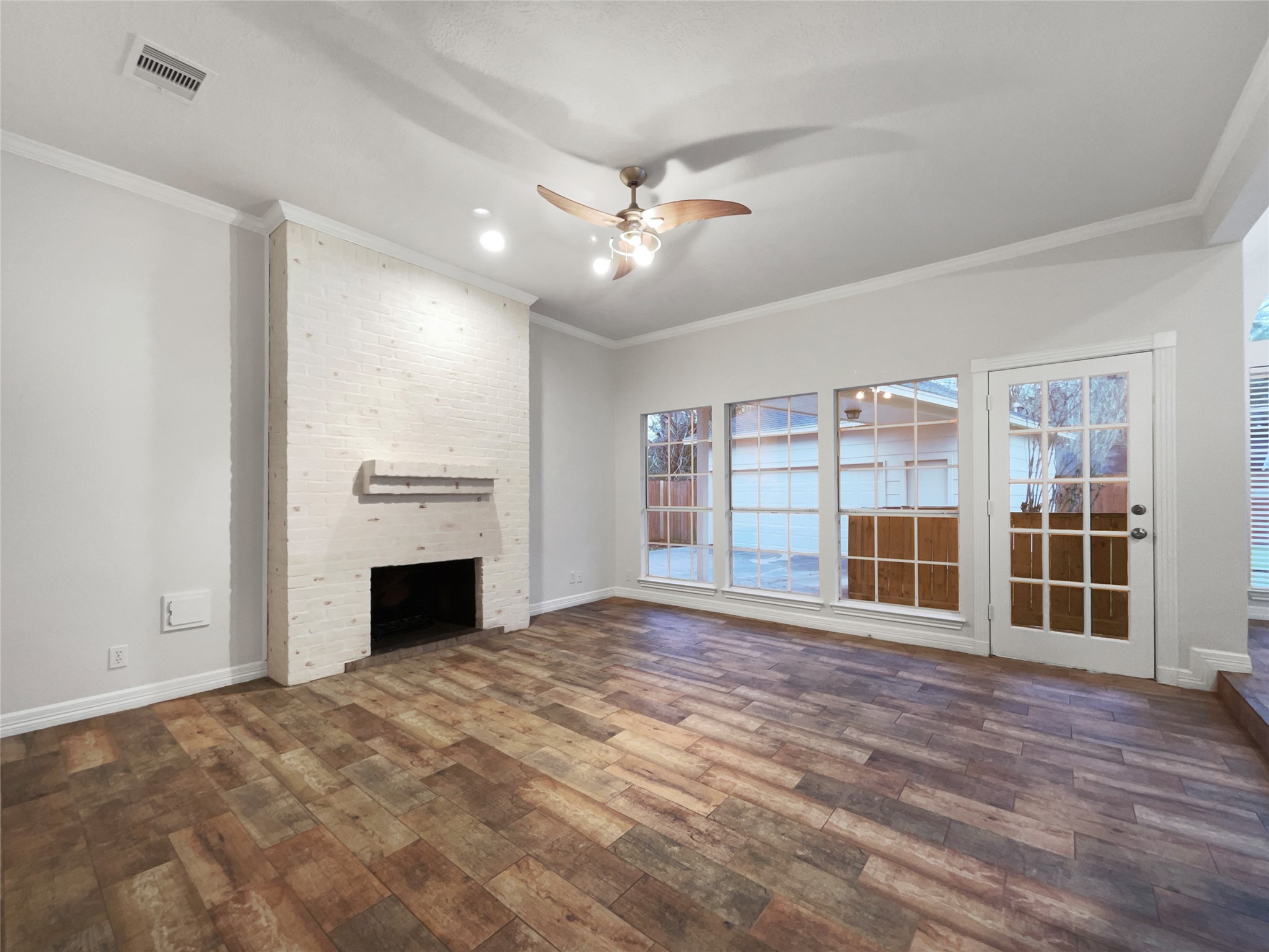 6107 Hampton Way Court Spring, TX 77389 - Photo 3 of 22 a view of empty room with wooden floor and fireplace