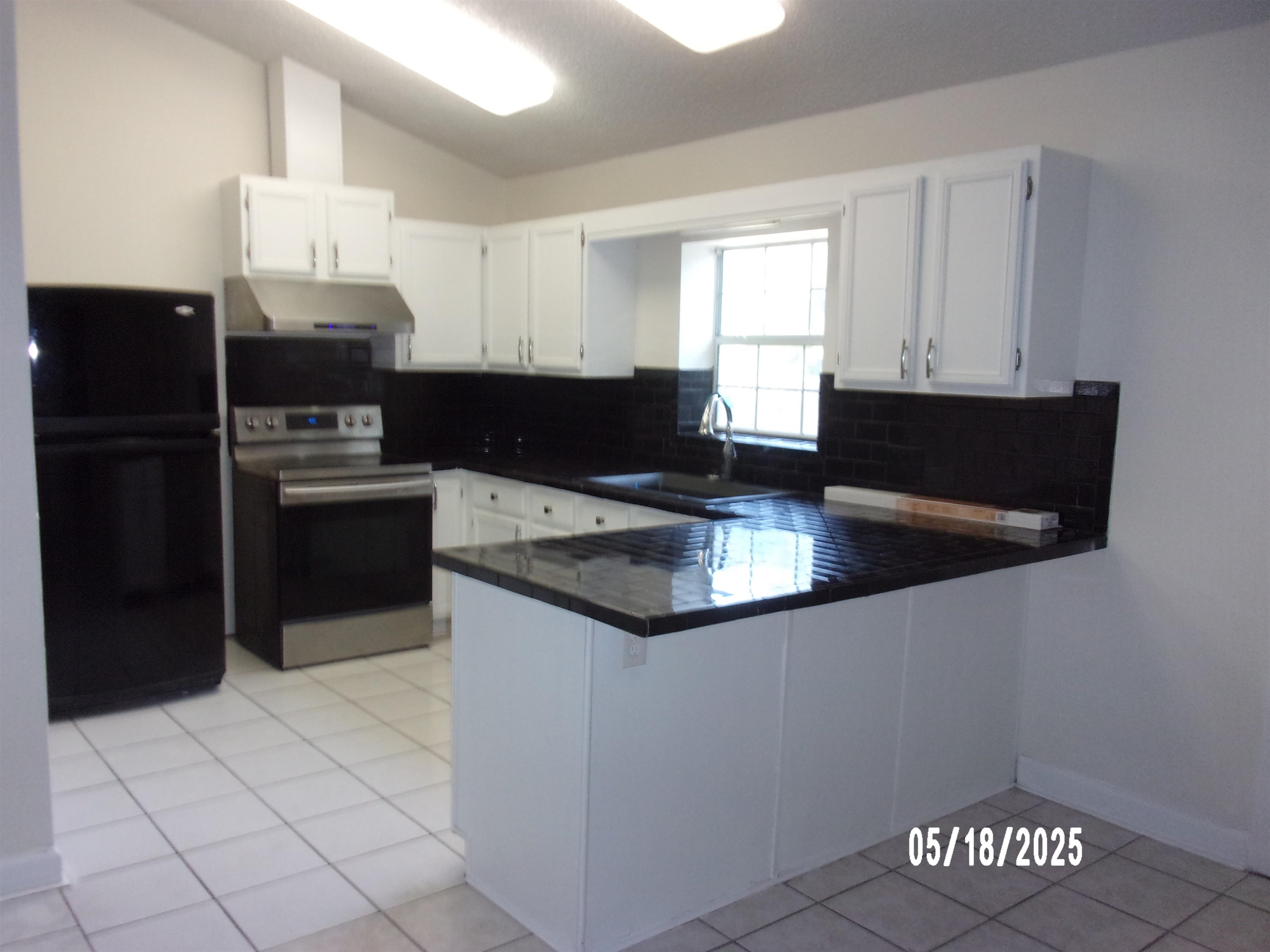 239 Cornell Road St. Augustine, FL 32086 - Photo 7 of 27 a kitchen with granite countertop a refrigerator a stove and a sink
