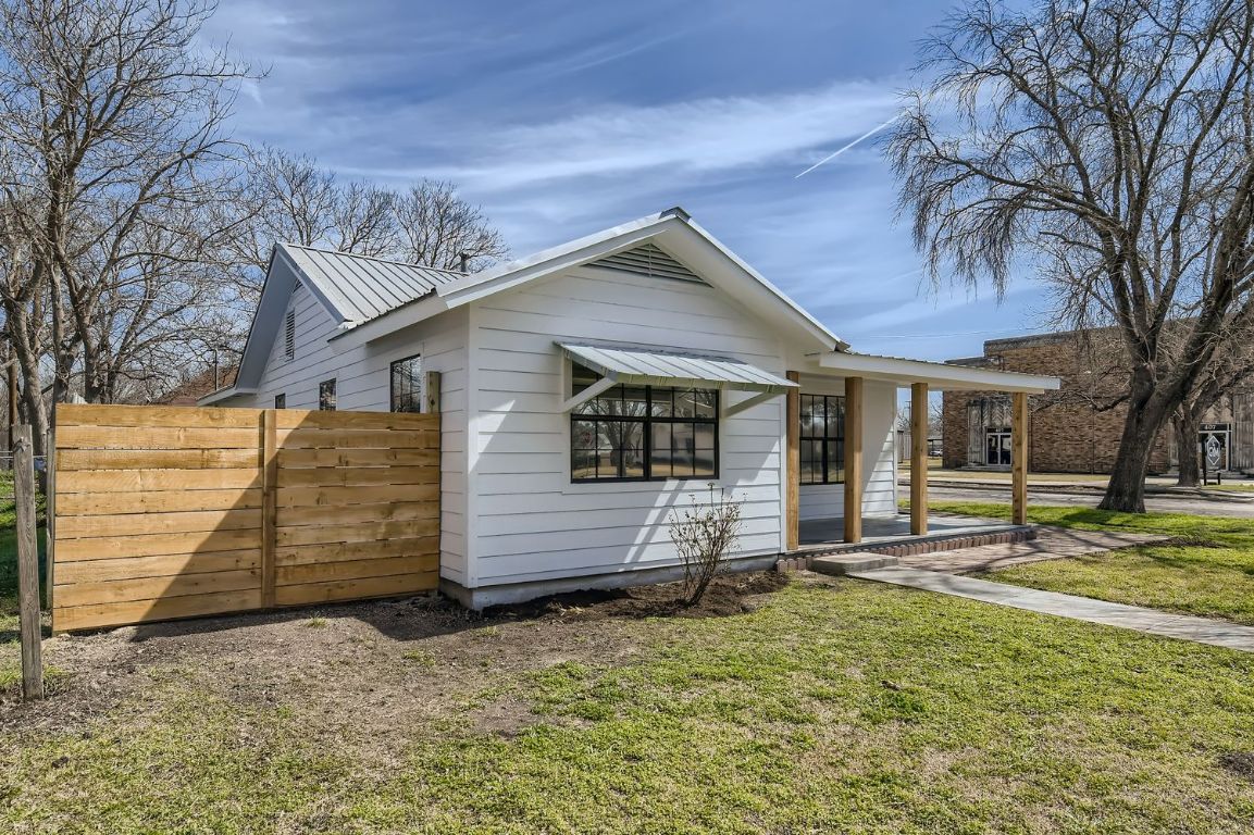 View of front facade with a metal roof and a porch