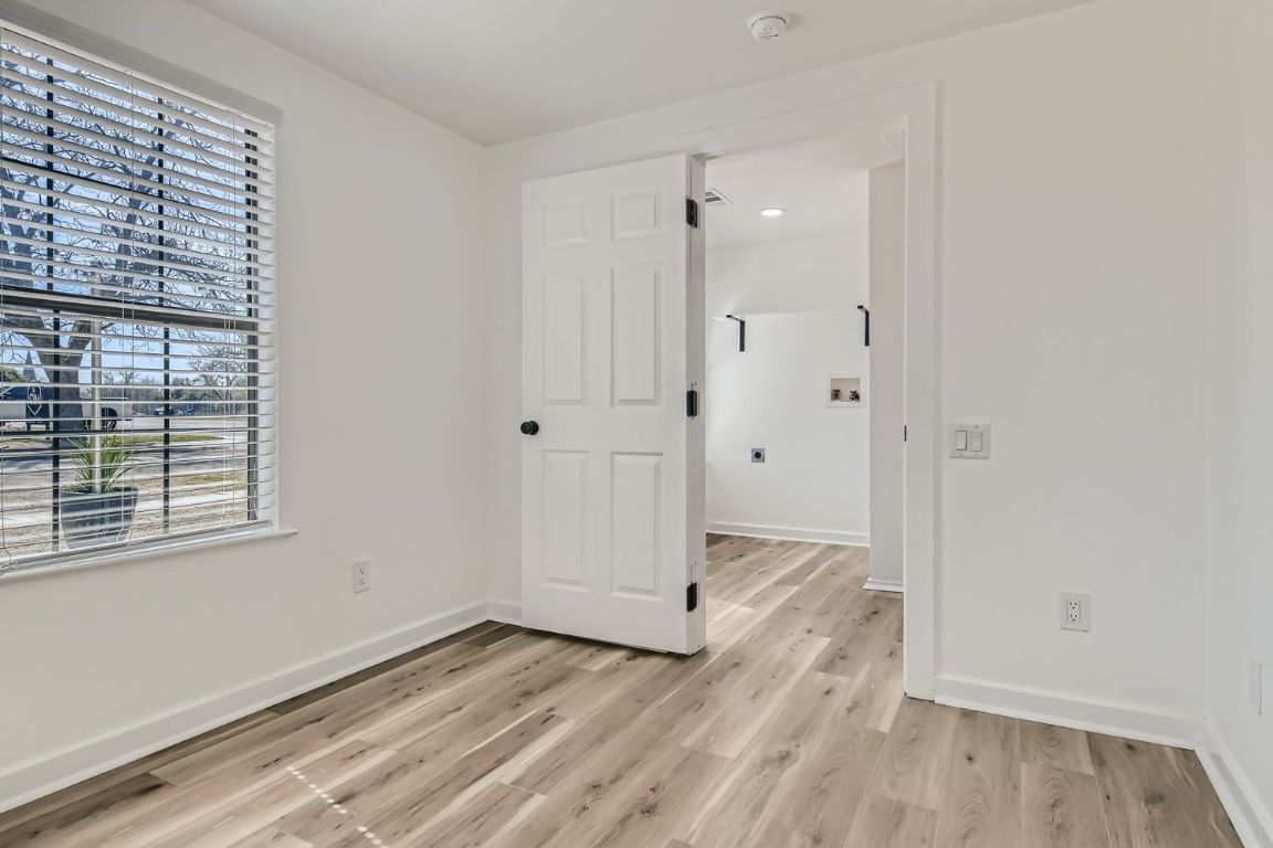 902 Hackberry Street Taylor, TX 76574 - Photo 13 of 29 Empty room with light wood finished floors and baseboards